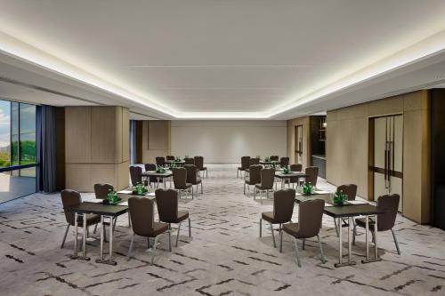 a meeting room with tables and chairs in a building at Crowne Plaza Kunshan East by IHG in Kunshan