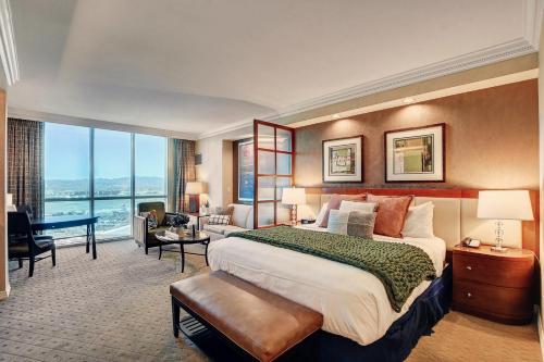 a hotel room with a large bed and a large window at MGM Studio Suite with POOL VIEW Tower 1 in Las Vegas