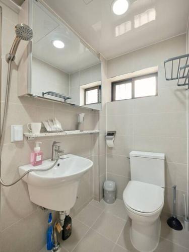 a bathroom with a white toilet and a sink at Haru Stay in Seoul