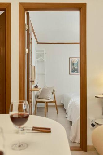 a room with a bed and a glass of wine at Haru Stay in Seoul