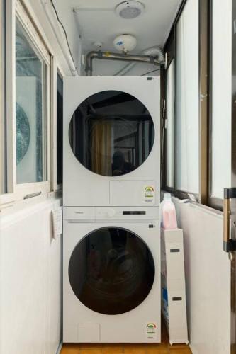 two washing machines are in a small room at Haru Stay in Seoul