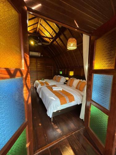 a bedroom with a large bed in a house at Golden Chenang Village in Pantai Cenang