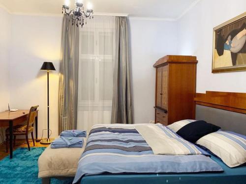 a bedroom with a bed and a table and a desk at VILLA GIULIETTA BUDAPEST with GARDEN, FREE PARKING in Budapest
