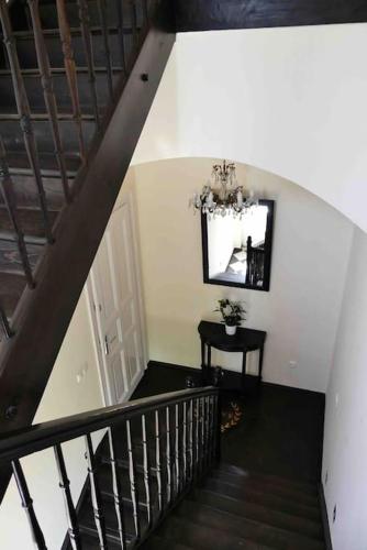 a staircase with a mirror and a table in a room at VILLA GIULIETTA BUDAPEST with GARDEN, FREE PARKING in Budapest
