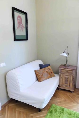 a white couch in a living room with a table at VILLA GIULIETTA BUDAPEST with GARDEN, FREE PARKING in Budapest