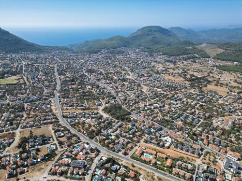 an aerial view of a city with mountains in the background at Larimar Suite Hotel in Oludeniz