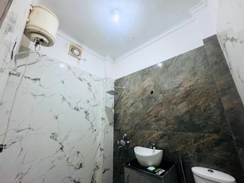 a bathroom with a toilet and a sink at Staybook The Rudveda Resort - Free High Tea near Pool Area in Rāmnagar