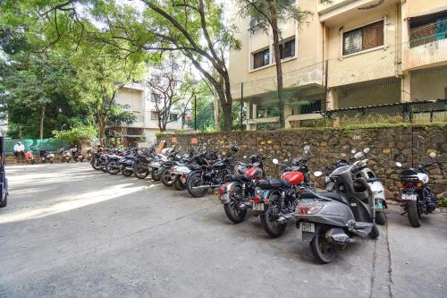 a row of motorcycles parked next to a building at FabHotel Olive Suite - Near Airforce get in Pune