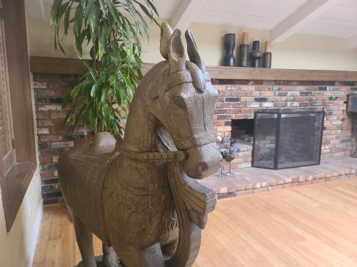a statue of a horse in a living room with a fireplace at Westside Retreat w Yard, Grill, Hot Tub, Near Sofi Stadium, LAX, and the Beach in Los Angeles