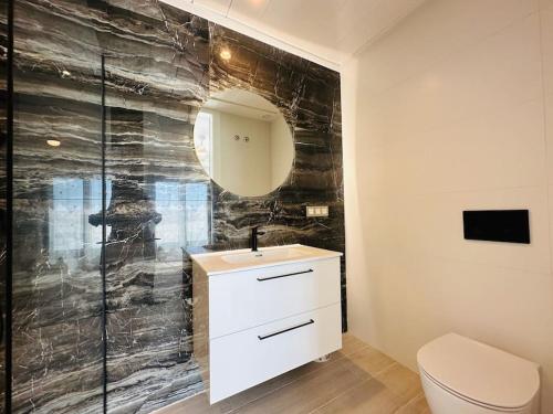 a bathroom with a white sink and a toilet at Villa Finestrat Benidorm Golf y Playa in Cala de Finestrat