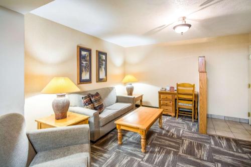 a living room with a couch and a table at Clarion Inn Grand Junction Airport in Grand Junction