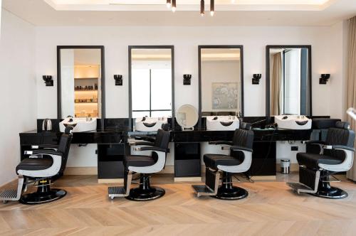 a bathroom with four sinks and mirrors at Waldorf Astoria Doha West Bay in Doha