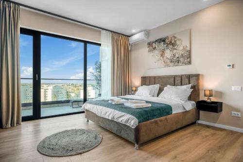 a bedroom with a large bed and a large window at Majestic Skyline in Balta Albă