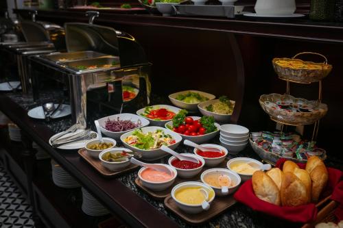 a buffet line with many different dishes of food at Serene Central Hotel in Hanoi