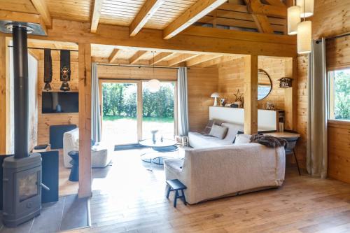a living room with a fireplace in a log cabin at Chalet Ilca in Thollon
