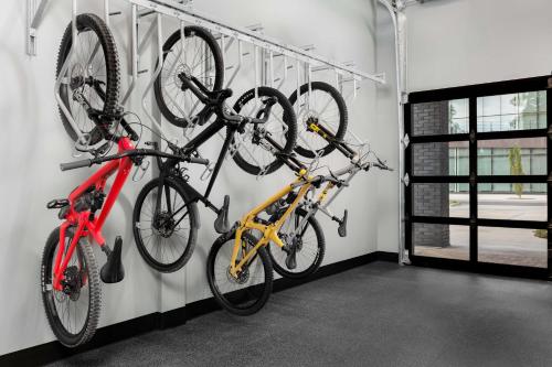 three bikes hanging on a wall in a garage at Motto By Hilton Bentonville Downtown in Bentonville