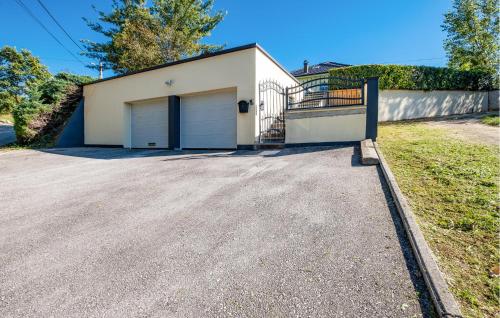 a house with a garage on a driveway at 3 Bedroom Nice Home In Vurnovec in Ðurđekovec