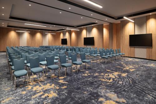 a conference room with chairs and screens in it at Park Inn by Radisson Hotel & Apartments Kuwait in Kuwait