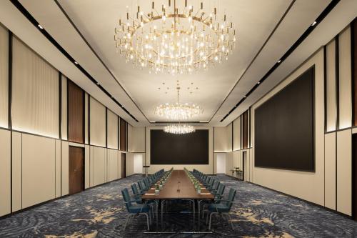 a long conference room with a long table and chairs at Park Inn by Radisson Hotel & Apartments Kuwait in Kuwait