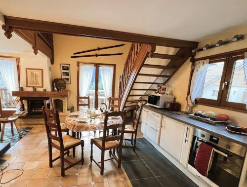 une cuisine avec une table et des chaises dans une pièce dans l'établissement Chalet des Grémiloups, à Saint-Gervais-les-Bains