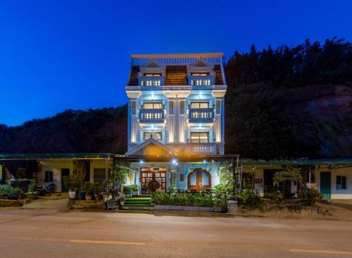 a large building with a blue sky in the background at Sapa TT Homestay in Sa Pa