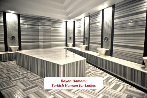 a bathroom with a row of urinals and toilets at Yalova Lova Hotel & SPA Yalova in Yalova