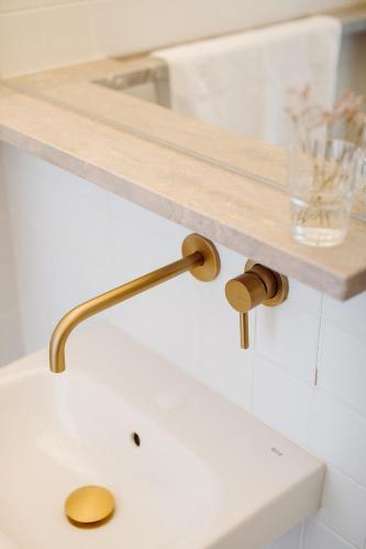 a bathroom sink with a wooden shelf above it at THE MODERNIST, Architecture experience in Faro