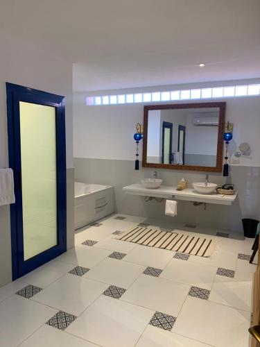 a bathroom with two sinks and a mirror at Lazib Inn Resort & Spa in Tunis