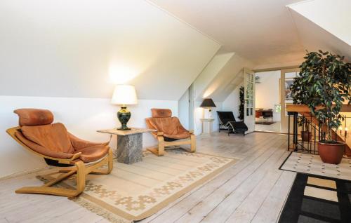 a living room with two chairs and a table at Amazing Home In Asperup in Asperup
