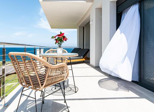 a balcony with a table and chairs and the ocean at Boutique apartments Myesis in Samothráki