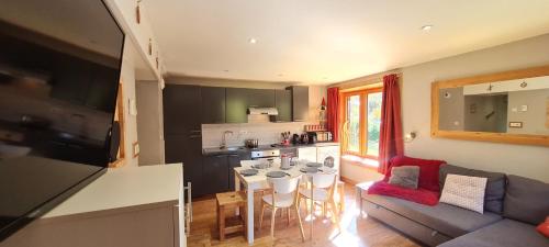 une cuisine et un salon avec une table et des chaises dans l'établissement CHALET COOP - B - 6 Pers, à Les Deux Alpes