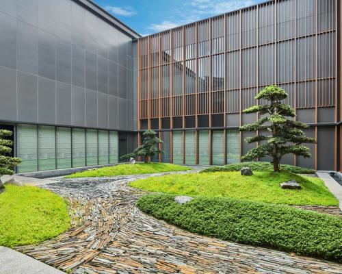 a garden in front of a building at DoubleTree by Hilton Jiangxi Fuzhou in Fuzhou