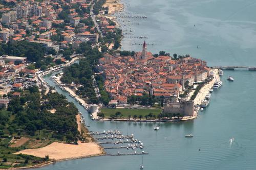 an aerial view of a city with boats in the water at Hotel Bellevue Trogir in Trogir