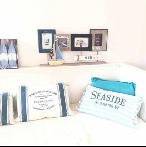 a shelf with pillows and pictures on it at Nido dell'Argentario - Porto Santo Stefano in Porto Santo Stefano