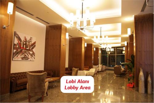 a lobby with couches and chairs and a chandelier at Yalova Lova Hotel & SPA Yalova in Yalova