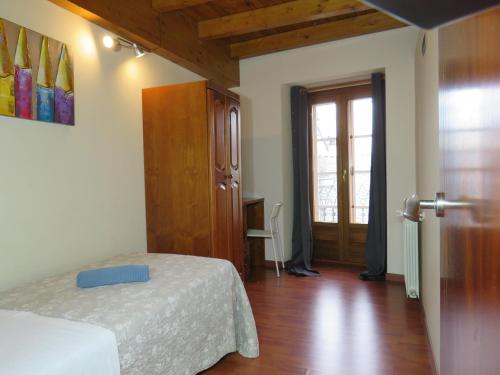 a bedroom with a bed and a door with a window at MIÑO 29 Viviendas turisticas in Lugo