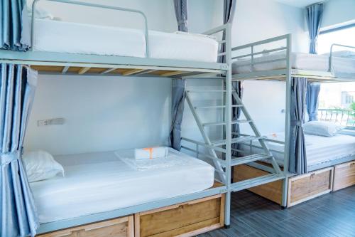 a group of bunk beds in a room at LiLa Inn & Motorbike Tours Ha Giang in Ha Giang