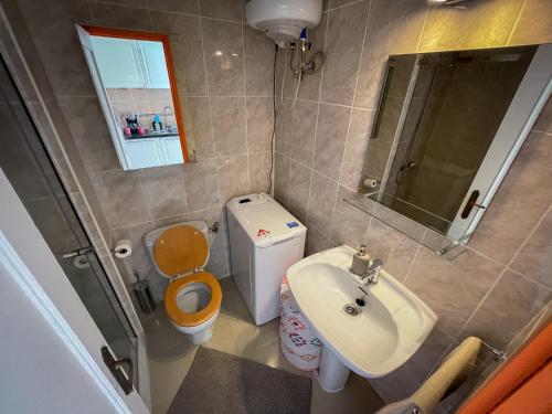 a small bathroom with a toilet and a sink at Casita Naranja - Bouganville in Costa de Antigua
