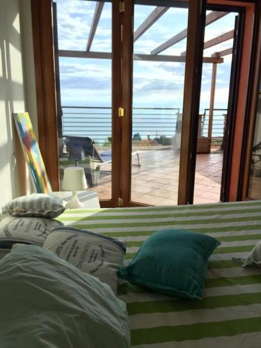 a bedroom with a bed with a view of the ocean at Argentario nice dreams in Porto Santo Stefano