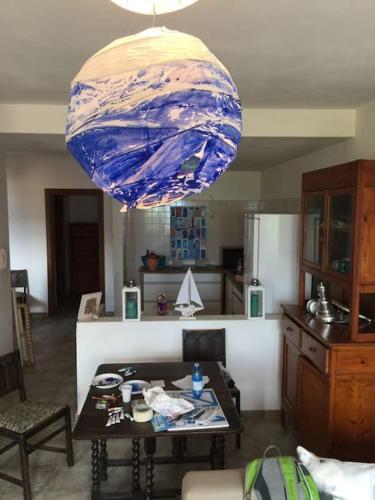 a chandelier hanging from a kitchen with a table and a tableablishangering at Argentario nice dreams in Porto Santo Stefano