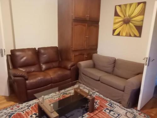 a living room with a couch and a coffee table at Creva House in Newtown