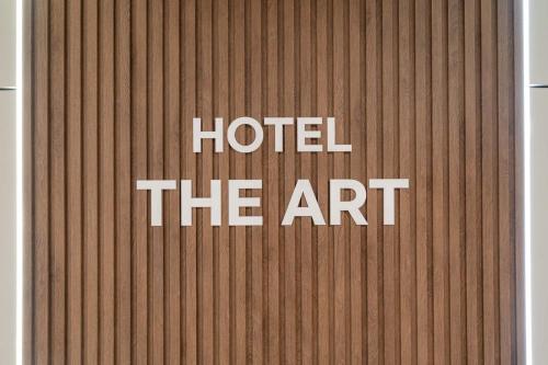 a sign that says hotel the art on a wall at Hotel THE ART UIWANG in Uiwang