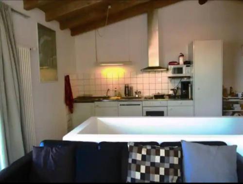 a kitchen with a large white tub in a room at Casa Vista Cadro Executive in Lugano