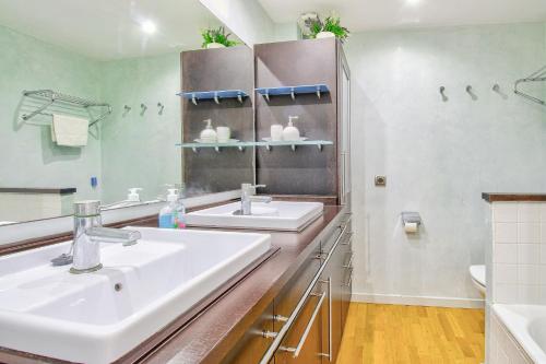 a bathroom with two sinks and a large mirror at Ca Se Predine by Rentallorca in Alcudia