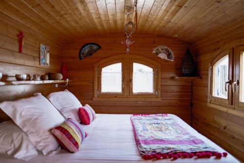 a bedroom with a bed in a wooden room at Lodge Sainte Helene Adult only in Saintes-Maries-de-la-Mer