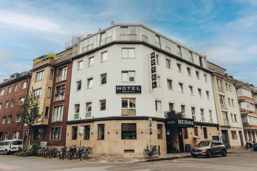 a large white building with a hotel sign on it at Boutique Hotel Düsseldorf Berial in Düsseldorf