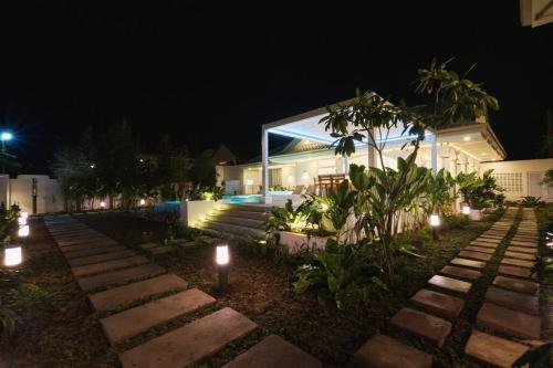 a house at night with lights in the yard at Alesea Tammocalao La Union Beachfront Villa - Jacuzzi, Two Pools in Bacnotan