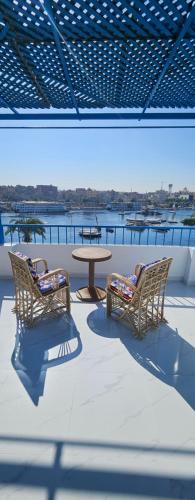 a patio with chairs and a table on a roof at La Terrace in Aswan