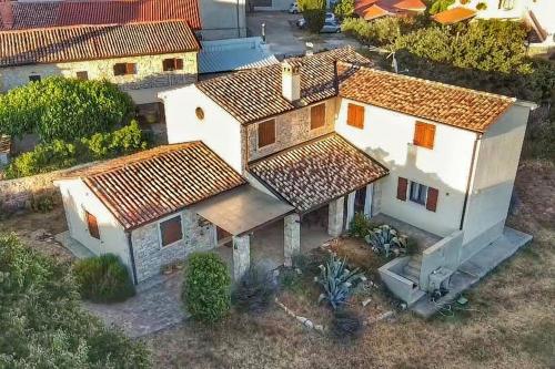 an overhead view of a white house with brown roofs at Casa Le Finide in Bale