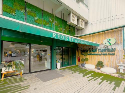 a store front of a building with a green awning at Regent Ramkhamhaeng 22 in Bangkok
